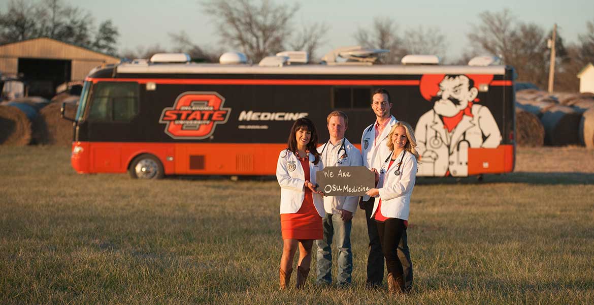 Students in open field holding sign stating "We are OSU Medicine"