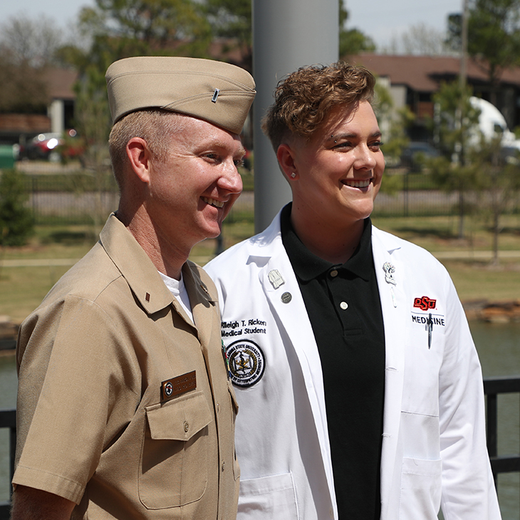 Medical student Rileigh Ricken (right) stands with Navy medical recruiter Lieutenant Junior Grade Aaron Furr after being commissioned as a Navy officer on Friday, April 15, 2022 at the OSU Center for Health Sciences.