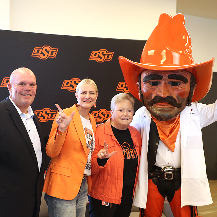 OSU Center for Health Sciences President Johnny Stephens, OSU President Dr. Kayse Shrum and OSU-CHS professor Dr. Robin Dyer pose with Pistol Pete at Dyer's retirement reception.