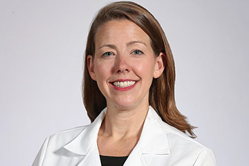 Dr. Sara Coffey in her physician white coat