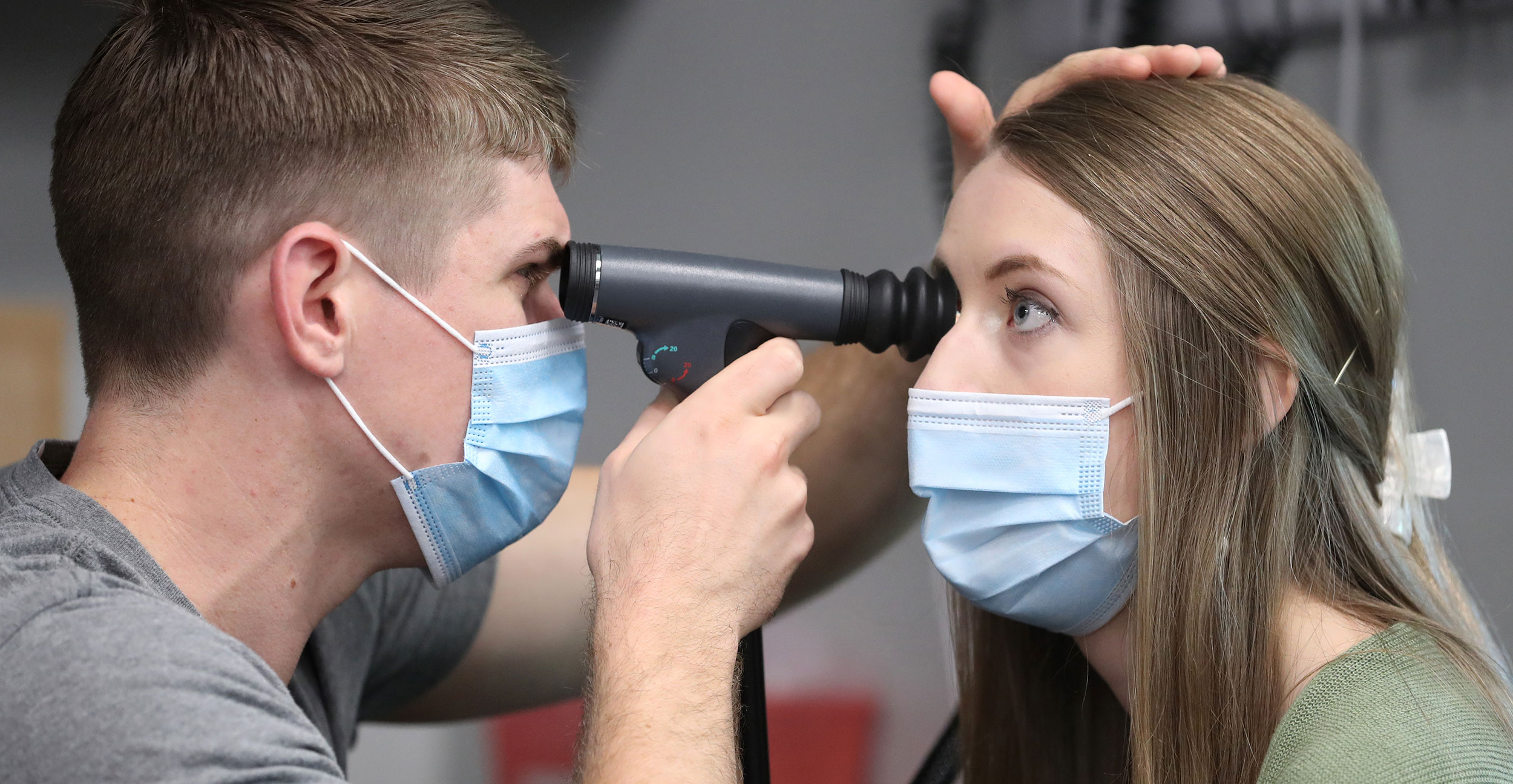Medical student Cooper Anderson (left) uses an ophthalmoscope on optometry student Baylee Moles (right) from Northeastern State University Oklahoma College of Optometry during an interprofessional education session at OSU College of Osteopathic Medicine at the Cherokee Nation in Tahlequah.