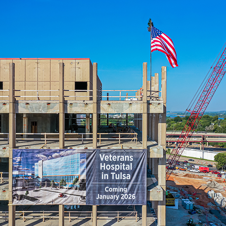 An American flag was placed by a crane at top of the Veterans Hospital in Tulsa as part of the project's topping off celebration on Aug. 27, 2024.