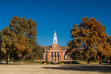 OSU’s Edmon Low Library is surrounded by golden fall foliage, highlighting the beauty of campus during the autumn semester.