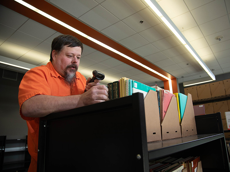 A man scanning books. 