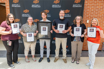 Faculty and staff proudly display their recognitions following the 2026 Faculty Staff Awards.