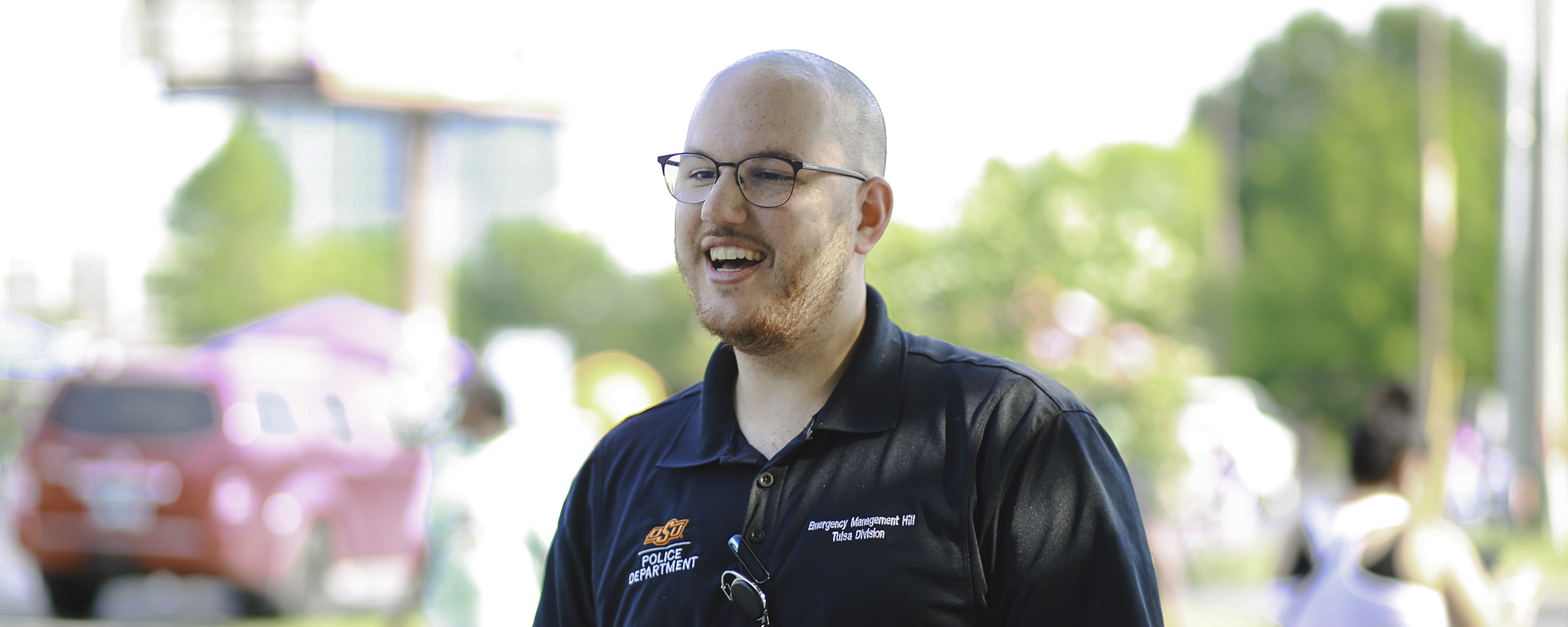 Emergency Manager Harrison Hill talks to some eventgoers at OSU-Tulsa's Back to School Bash event.