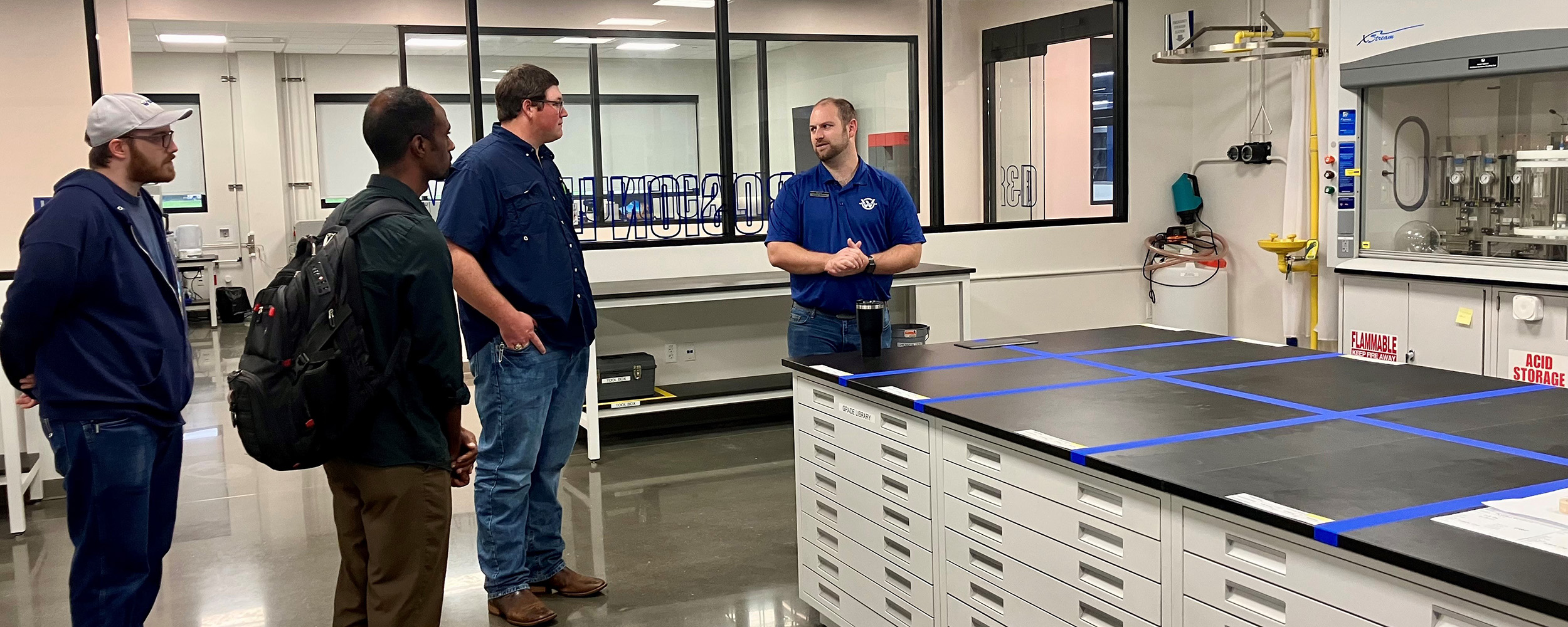 Two OSU-Tulsa students (middle) tour the Webco Tubing labs, seeing how their classwork applies in real world industry examples.