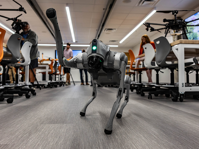 OAIRE's robotic dog waves to the camera inside Main Hall's newly rennovated 1300 wing, where STEM breakout sessions took place.