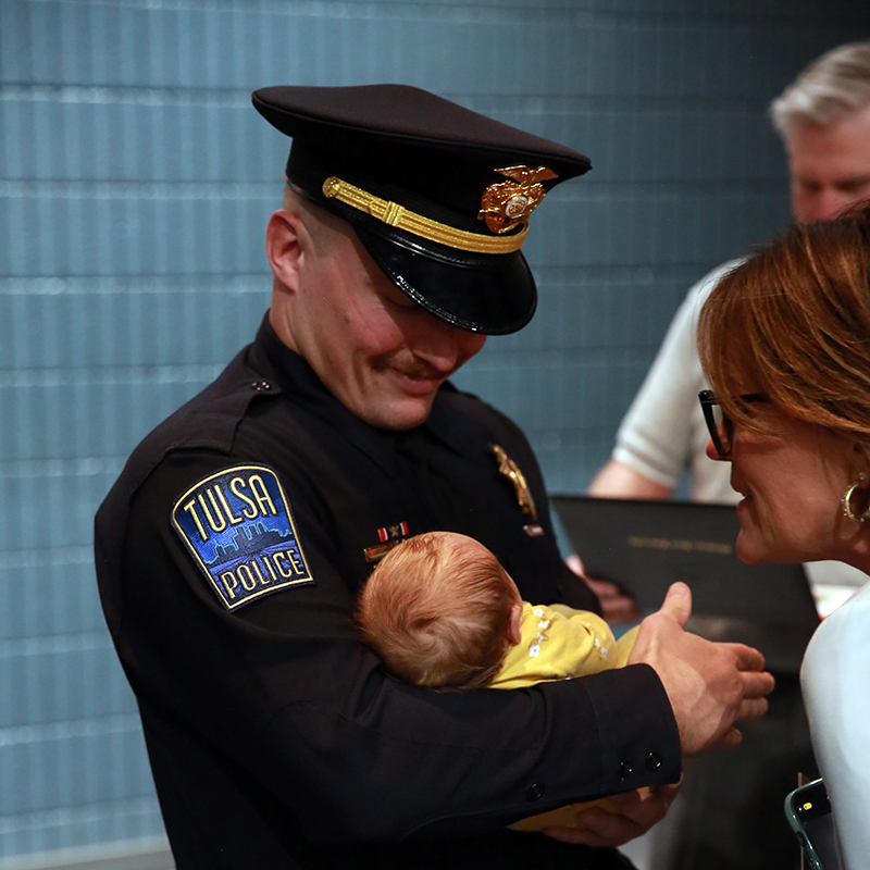 Officer Jared Brown, greeted by his family at the end of the ceremony.