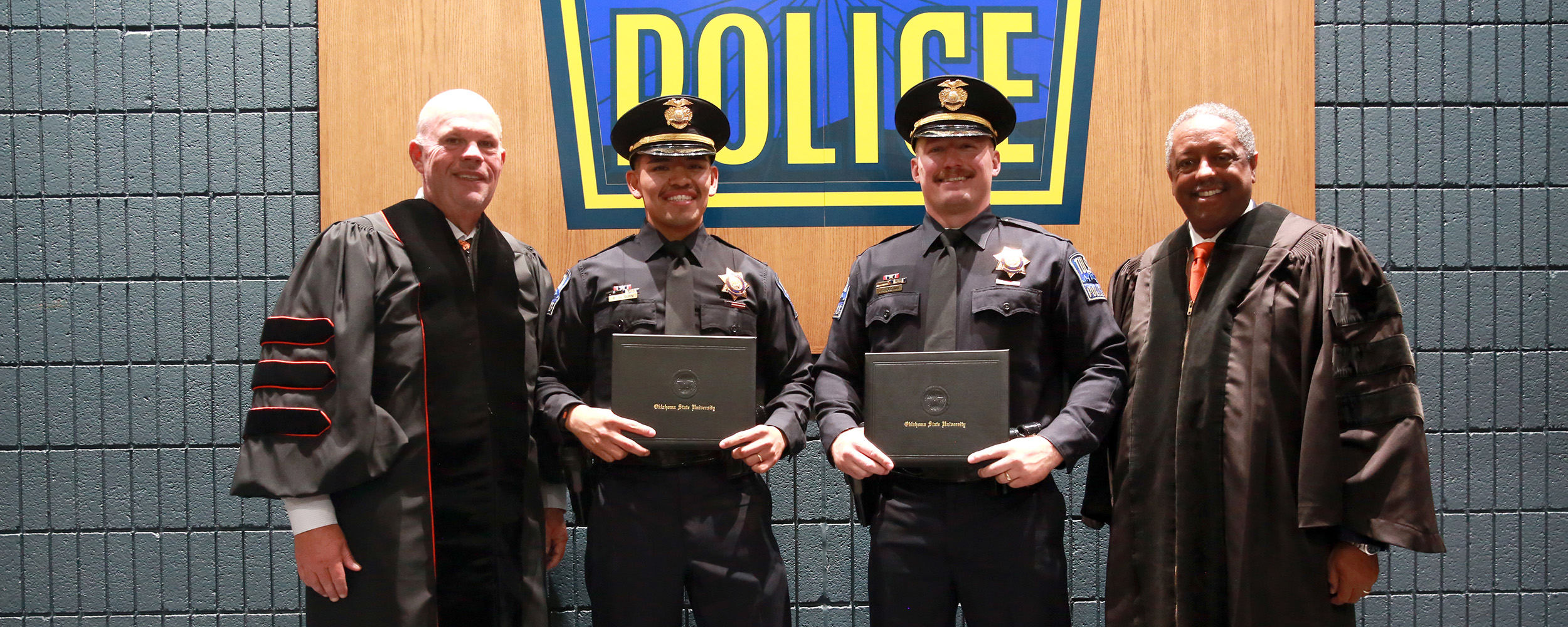 From left: OSU-Tulsa Interim President Johnny Stephens, Officer Brenden Olguin, Officer Jared Brown and Vice Provost and Dean of the College of Professional Studies Craig Freeman