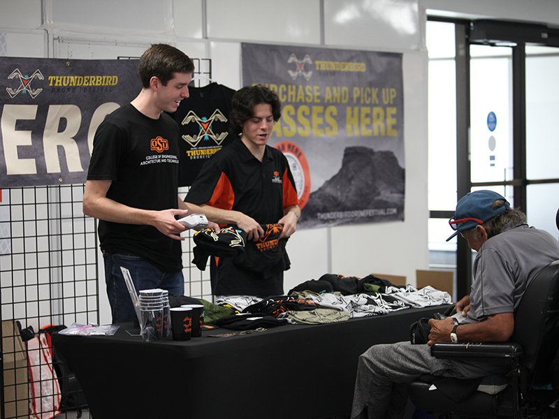 Volunteers help sell Thunderbird Drone Festival merch.
