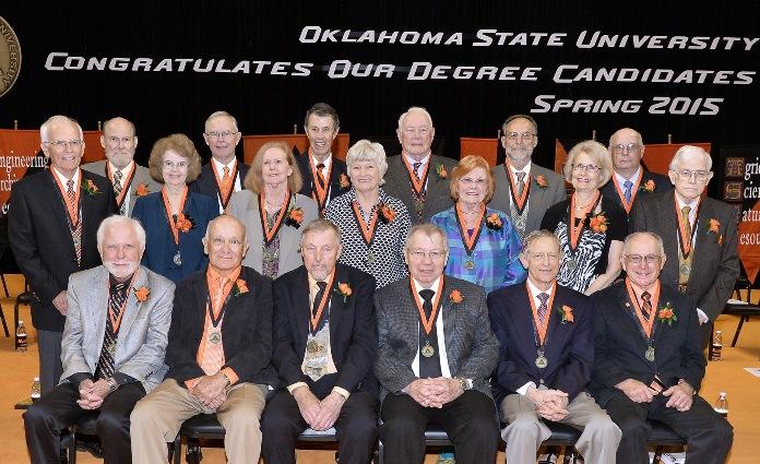 Around 20 people pose for a picture in Gallagher-Iba Arena.