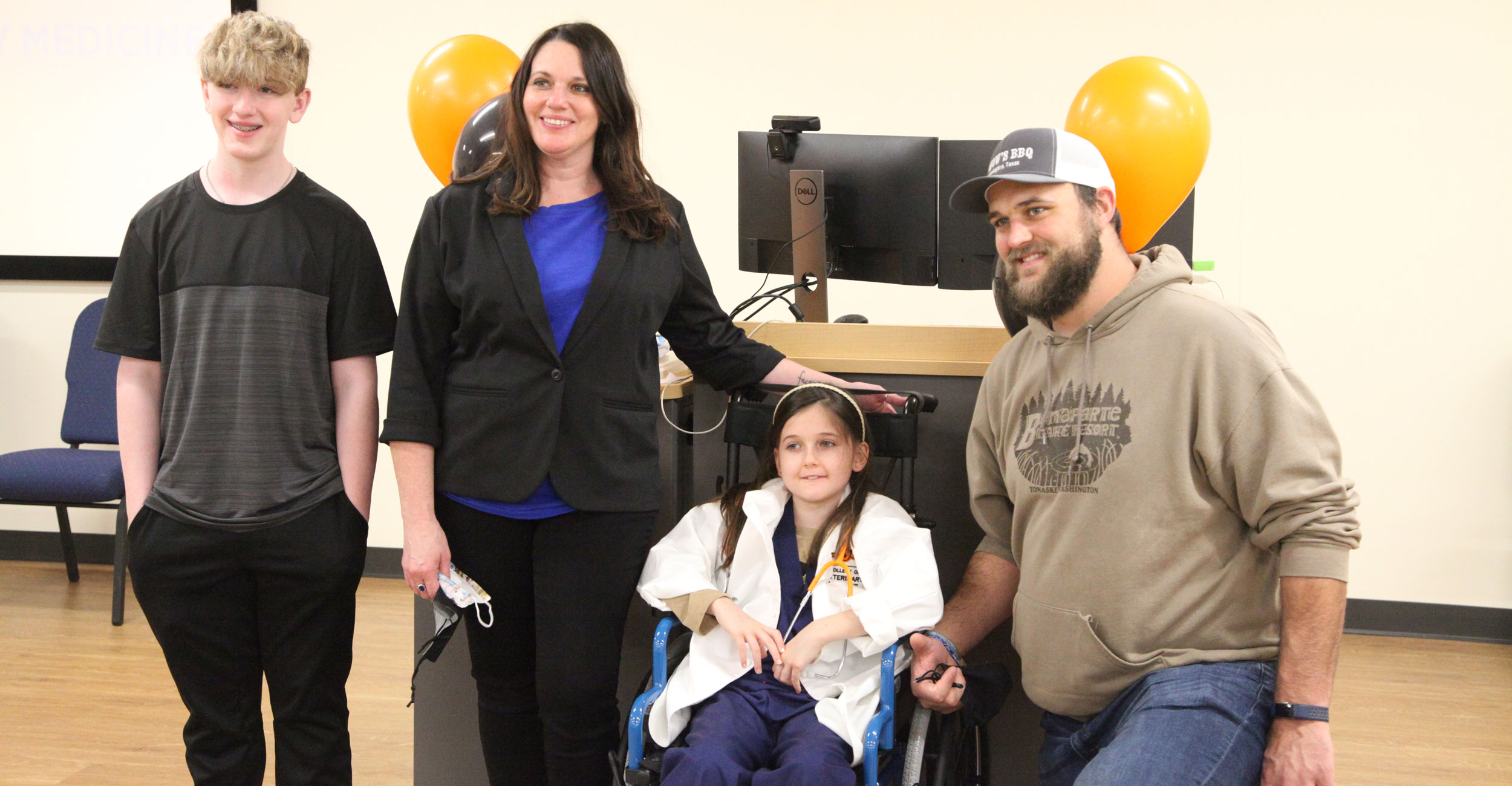 Addie, an 8-year-old cancer patient from Tulsa, visited OSU as part of the Make-A-Wish program. Pictured (left to right): Her brother, Tyler; her mom, Renee; Addie; and her dad, Ben.
