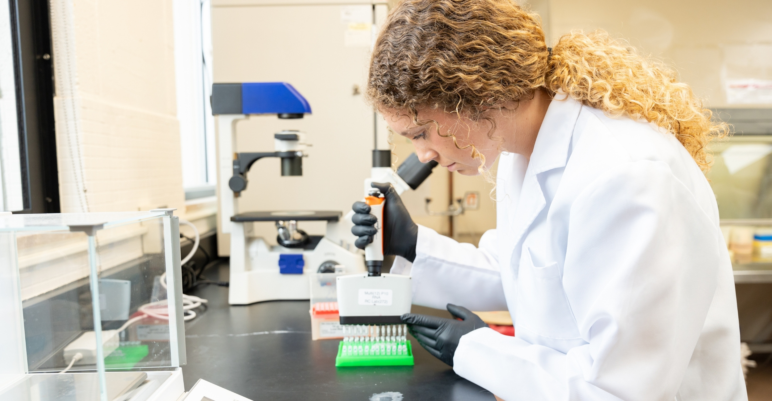 veterinary student in lab coat is doing research