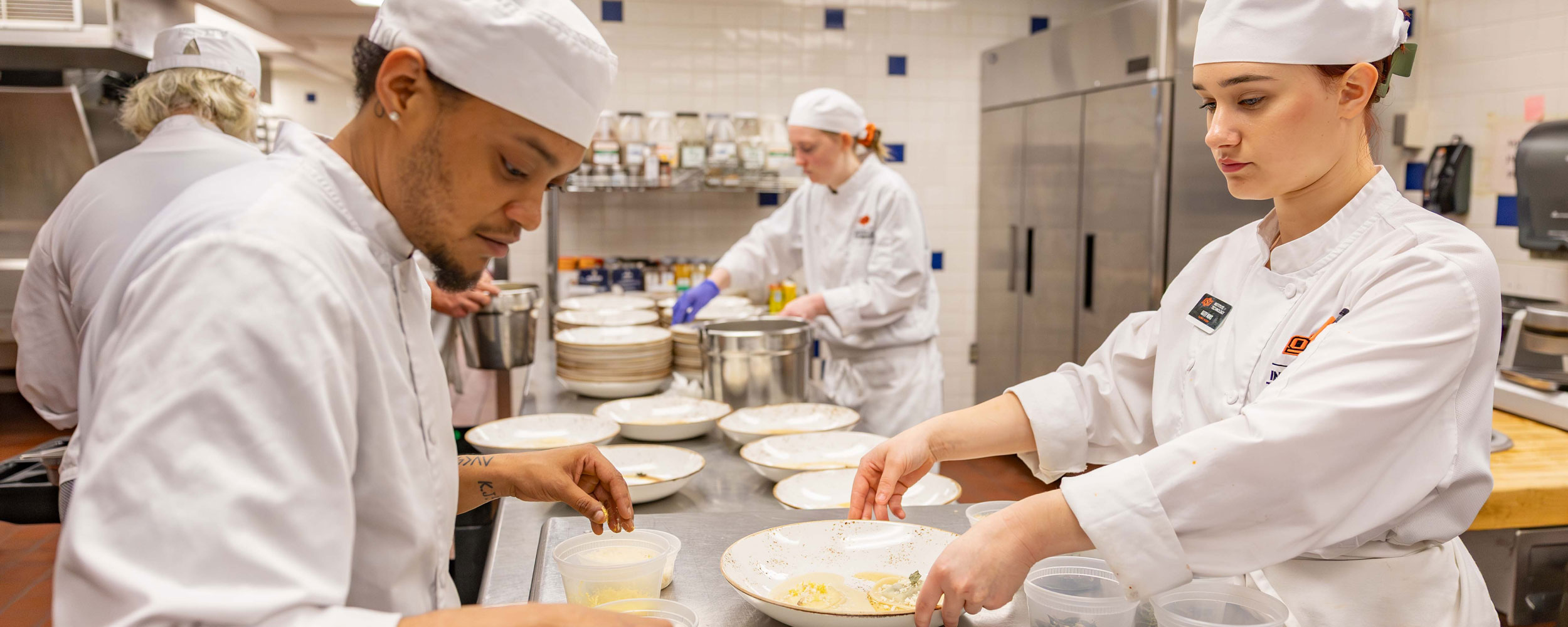 OSUIT Culinary Arts students work in the kitchen during the Cowboy Chef’s Table scholarship fundraiser on May 21. 