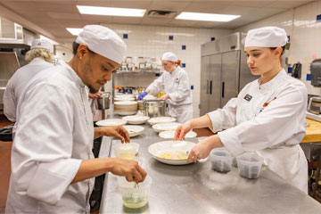 OSUIT Culinary Arts students work in the kitchen during the Cowboy Chef’s Table scholarship fundraiser on May 21.