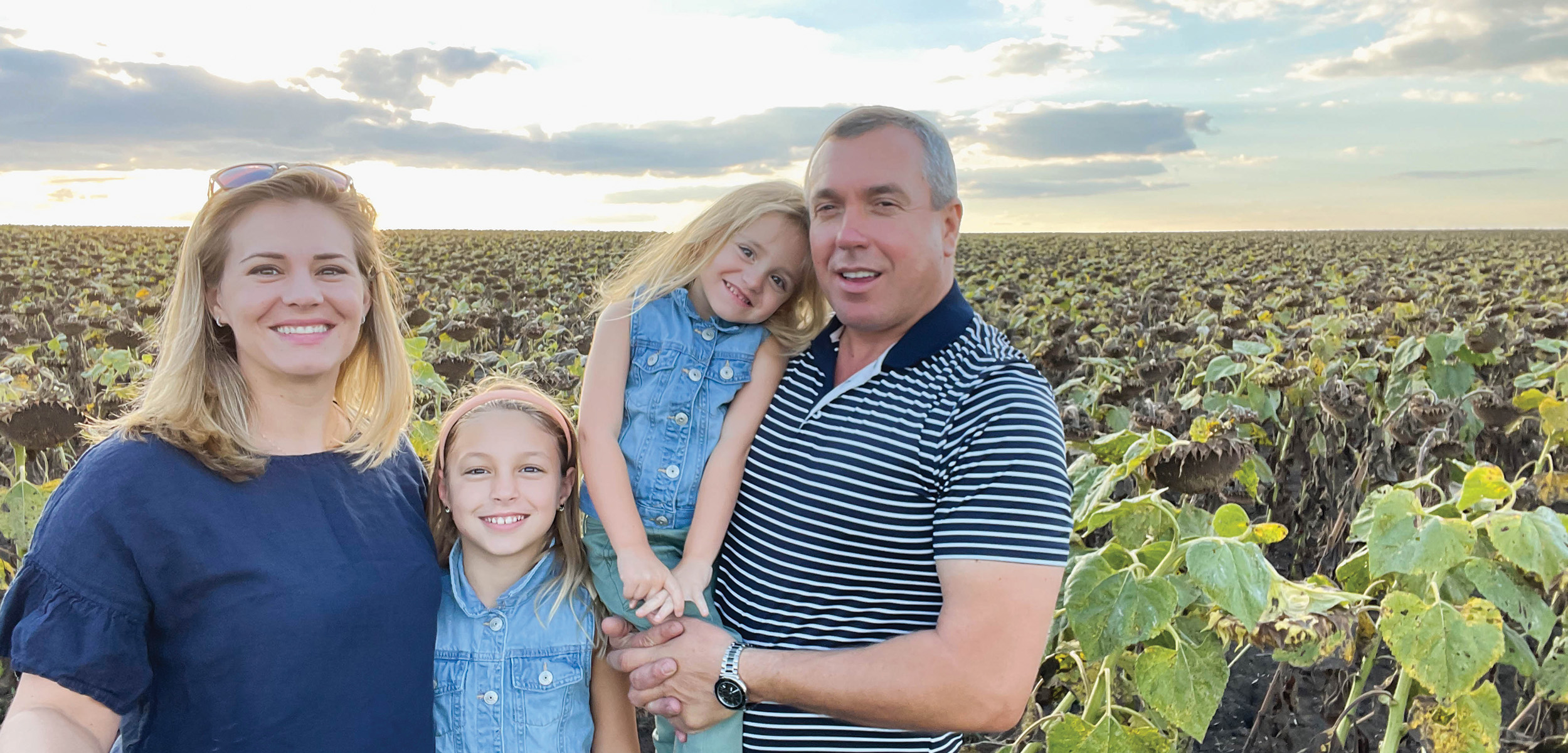 Kelsey Walters and her family are standing in their sunflower field in Moldova.