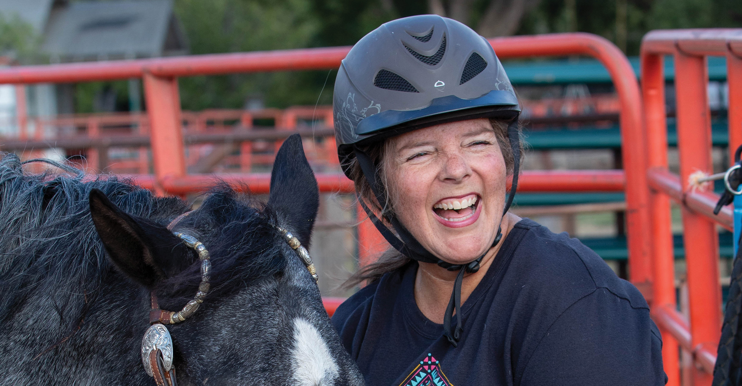 A smiling Debbie Shelton prepares her horse Harley for an evening riding session.