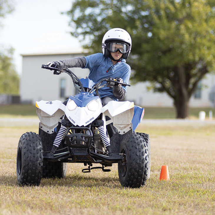 Bear Mitchell riding an ATV