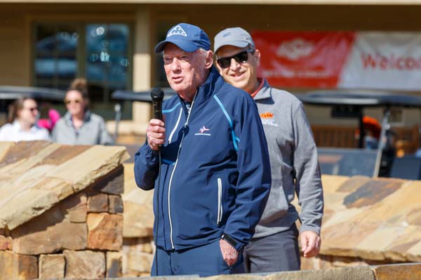 Dr. John Rooney from Folds of Honor speaks at the golf scramble, with former CAS dean Glen Krutz looking on.