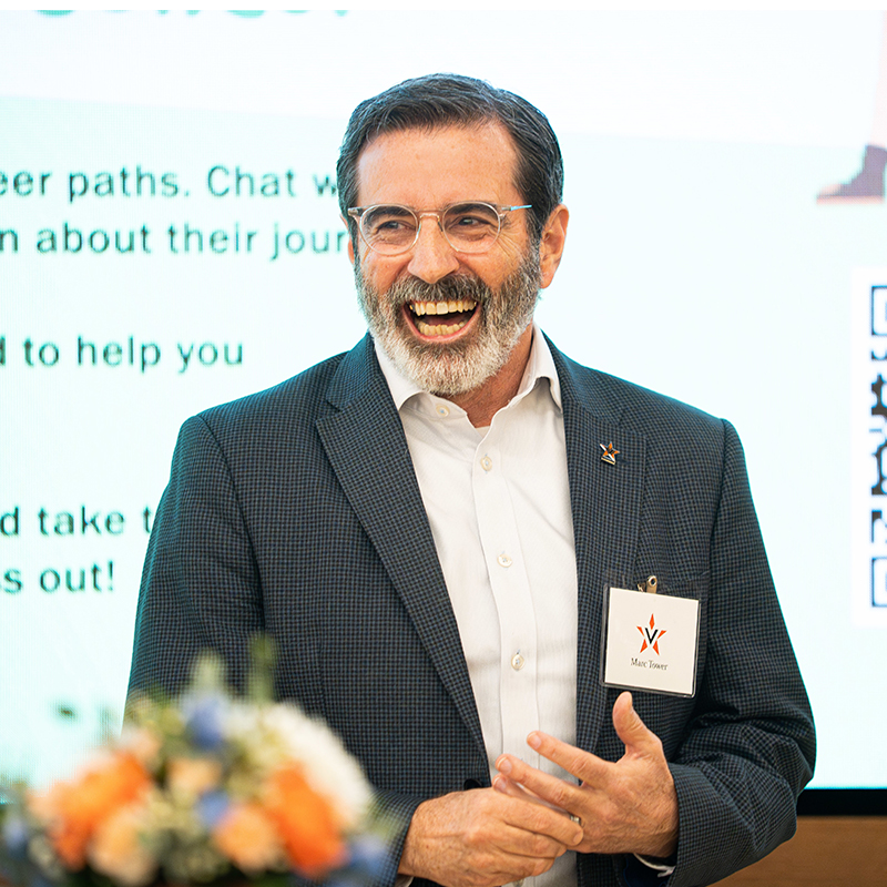 Marc Tower laughs during his introductory speech at the VEP reception
