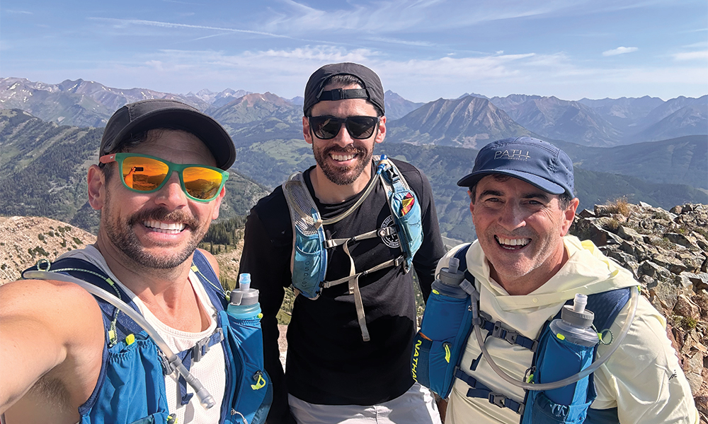The Tower boys pose at the top of a mountain on vacation