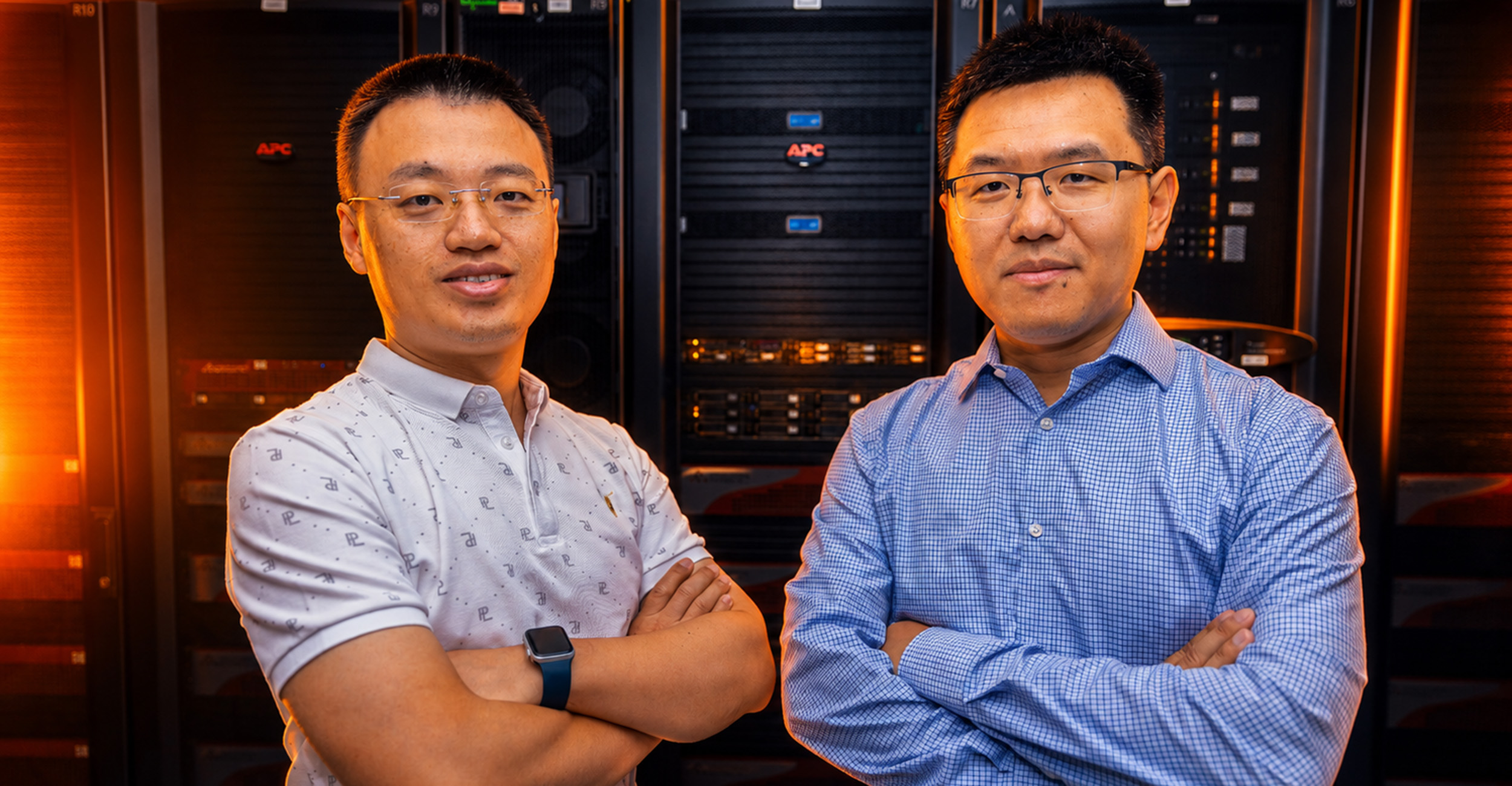 Dr. Xiaojin Aaron Sun and Dr. Rui Du in front of server racks