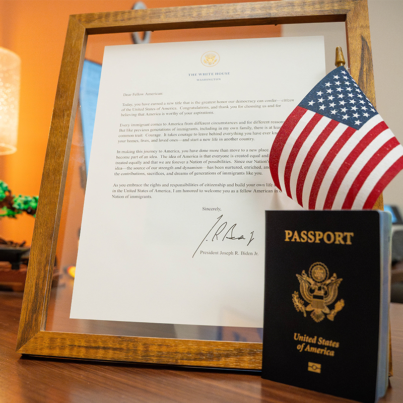At Rodrigo Tello's naturalization ceremony, he was given his blue U.S. passport, as well as this American flag and letter from then-president Joe Biden.
