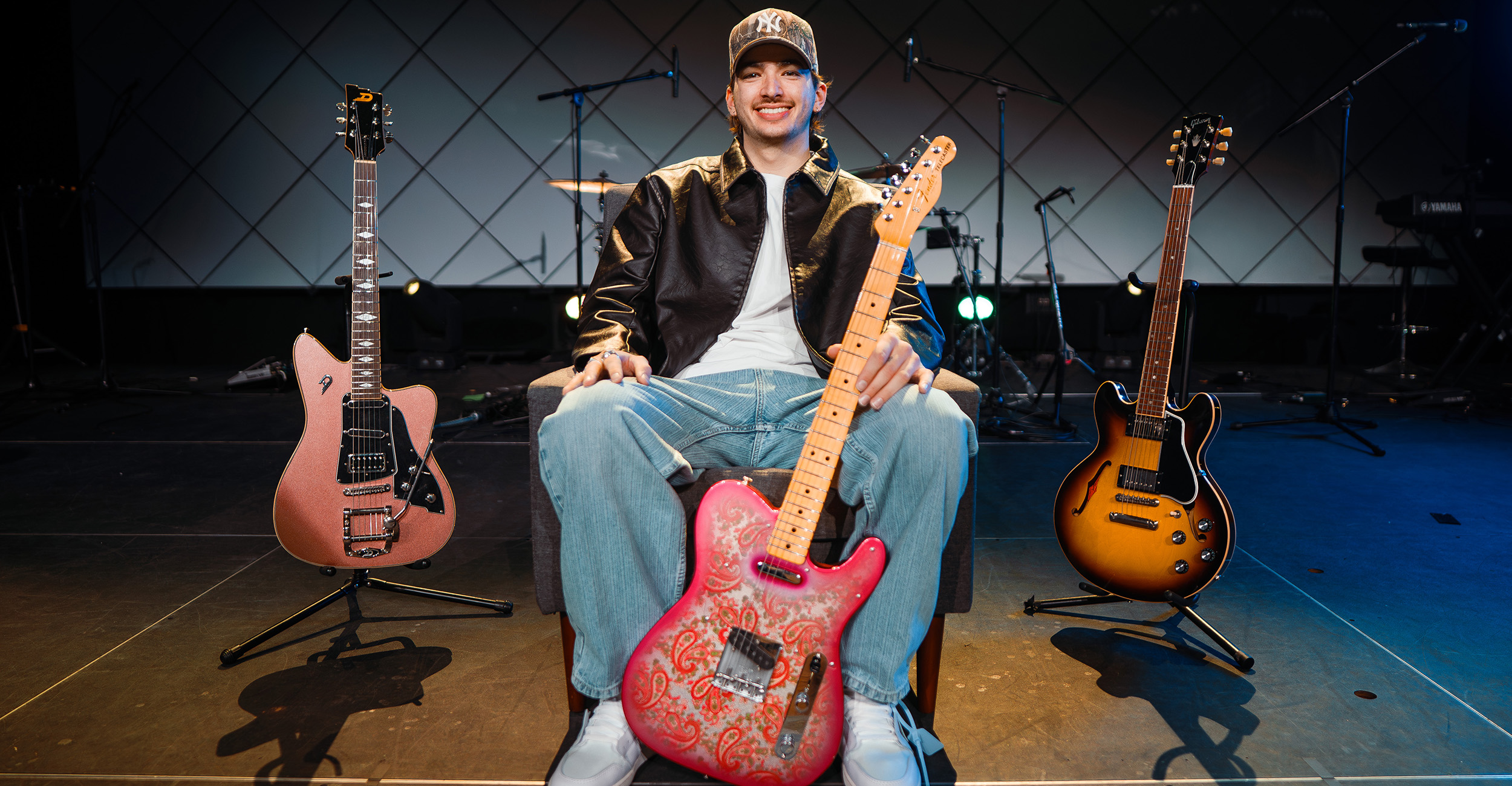 Zander Silva posing on stage with his guitars.