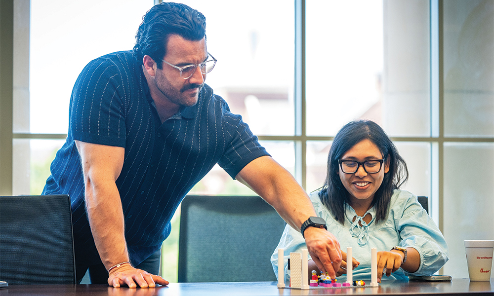 Rodrigo Tello helping a student construct a LEGO building during a LEGO Serious Play course. All MBA students at OSU are required to take this course.