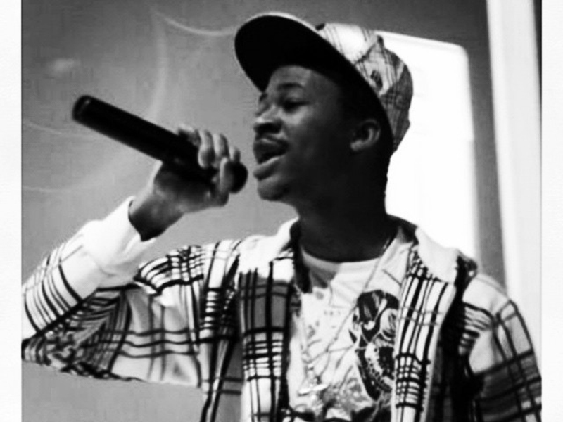 A young Abraham Terrah sings into a microphone.