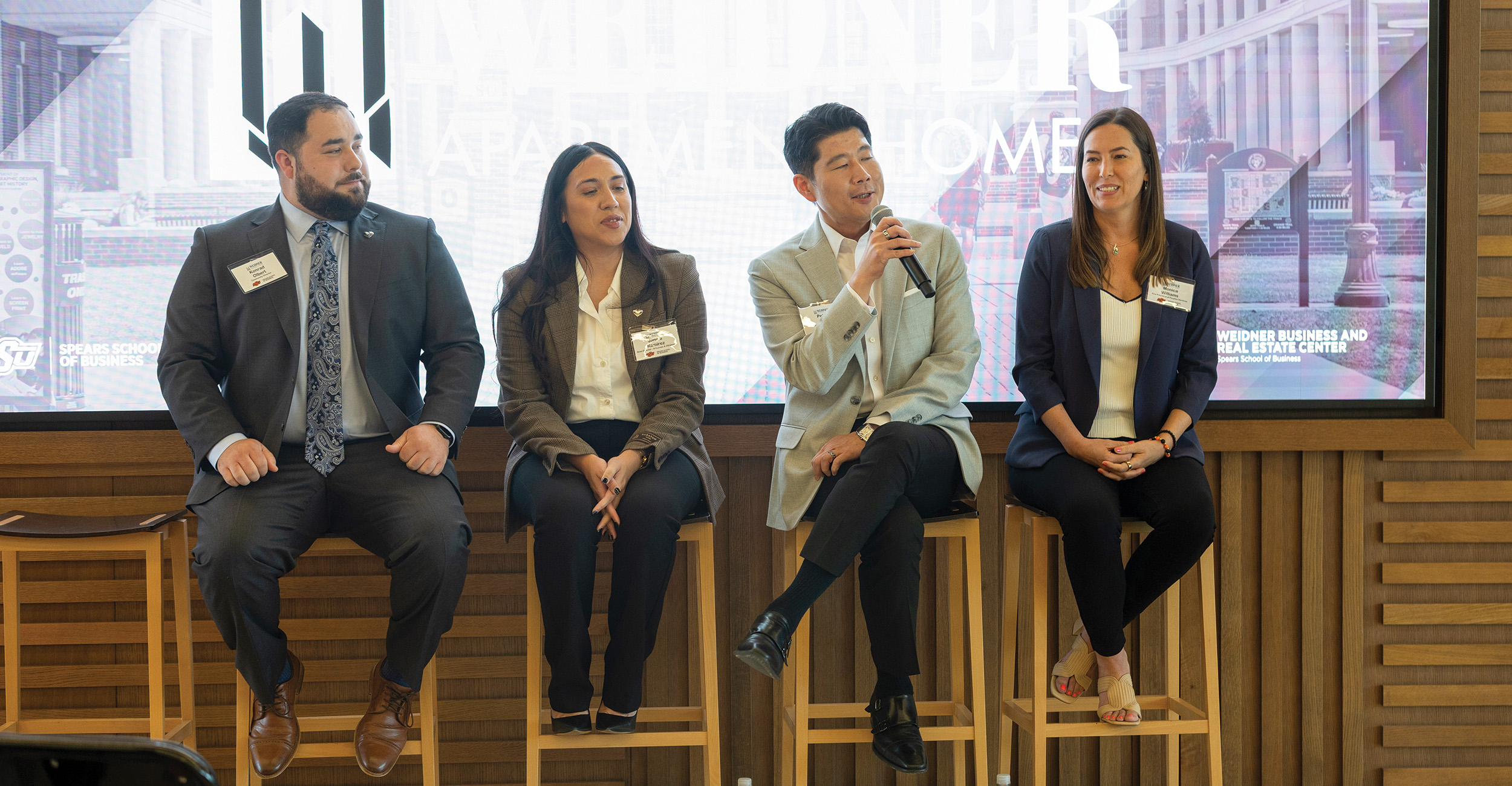 A guest panel from Weidner Apartment Homes speaks in the Business Building.
