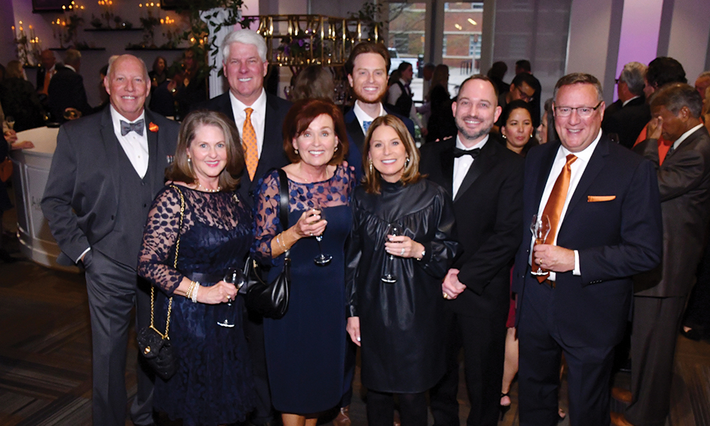 A group of distinguished Wine Forum patrons and donors pose as a group.