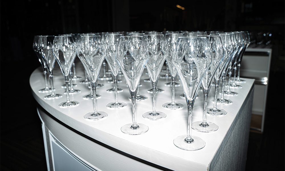 Dozens of white wine glasses ready for patrons to arrive prior to the Wine Forum.