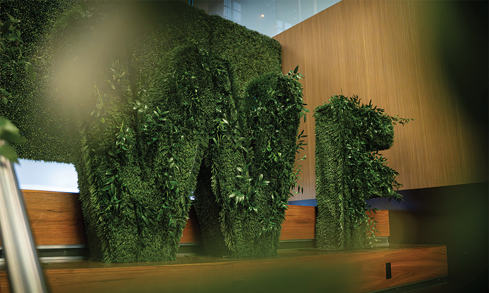 A plant display in the shape of "WF" for Wine Forum.