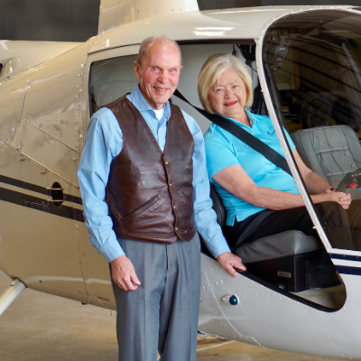 The Bookers posing with a plane