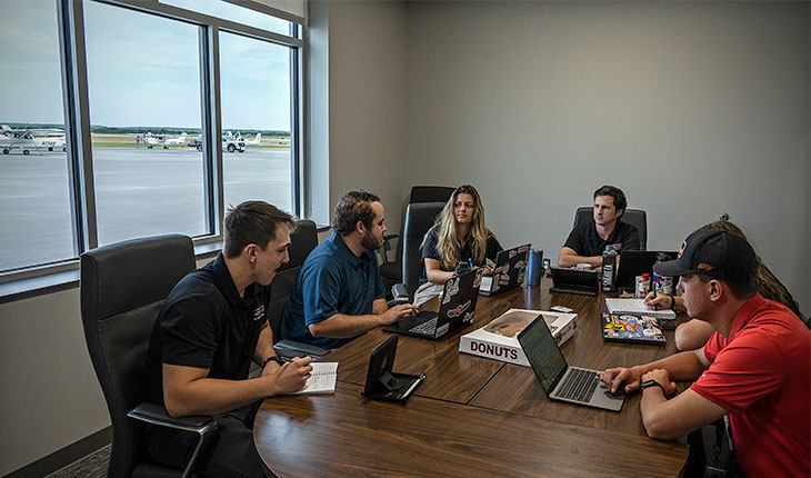 Students sit at Booker Flight Center conference table