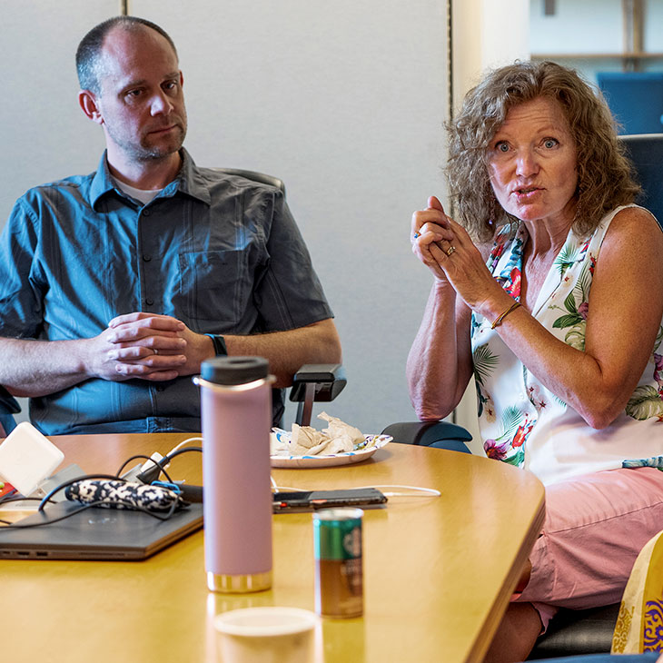 Man and woman sitting next to eachother at conference table