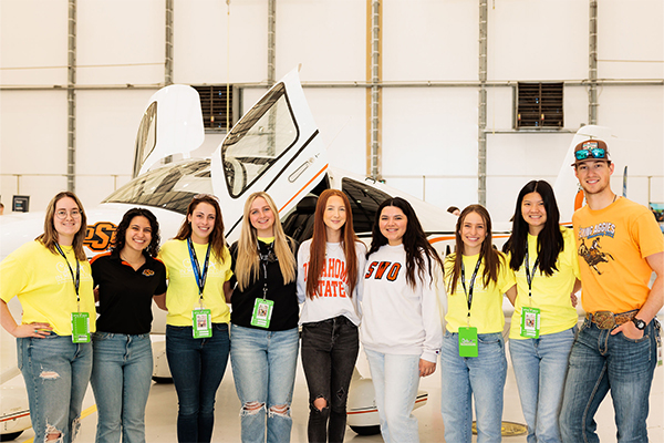 From left: Amelia Danker, Kristen Cunningham, Dana Friend, Sarah Schafer, Molly Bond, Ana-Michelle Ichazo, Molly Amsler, Chloe Behrends and Trace Liles share knowledge about aviation to attendees.