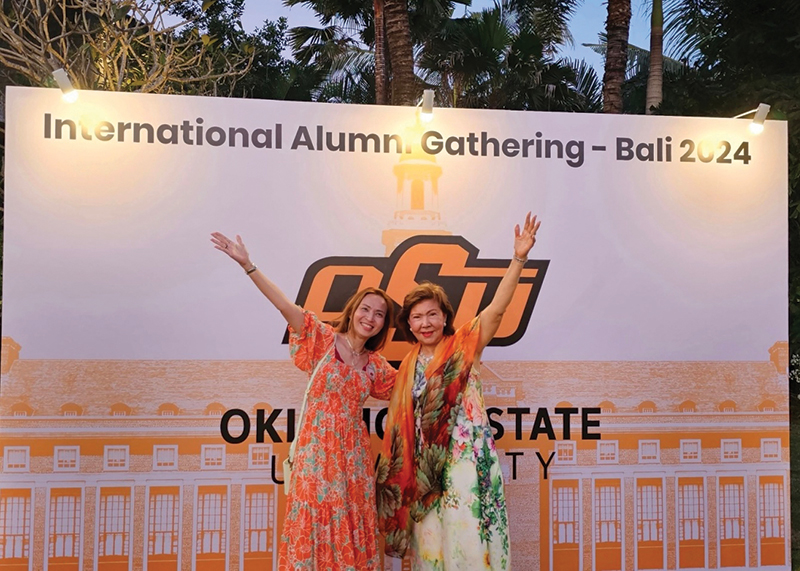 Gift and Lakhana pose together enthusiastically at the alumni event in Bali.