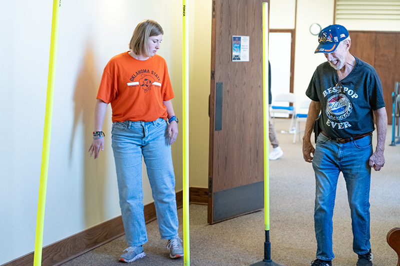 Recreational therapy student leads participant in Parkinson's CANe Project exercise. 
