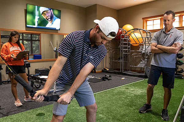Golfer evaluates swing strength