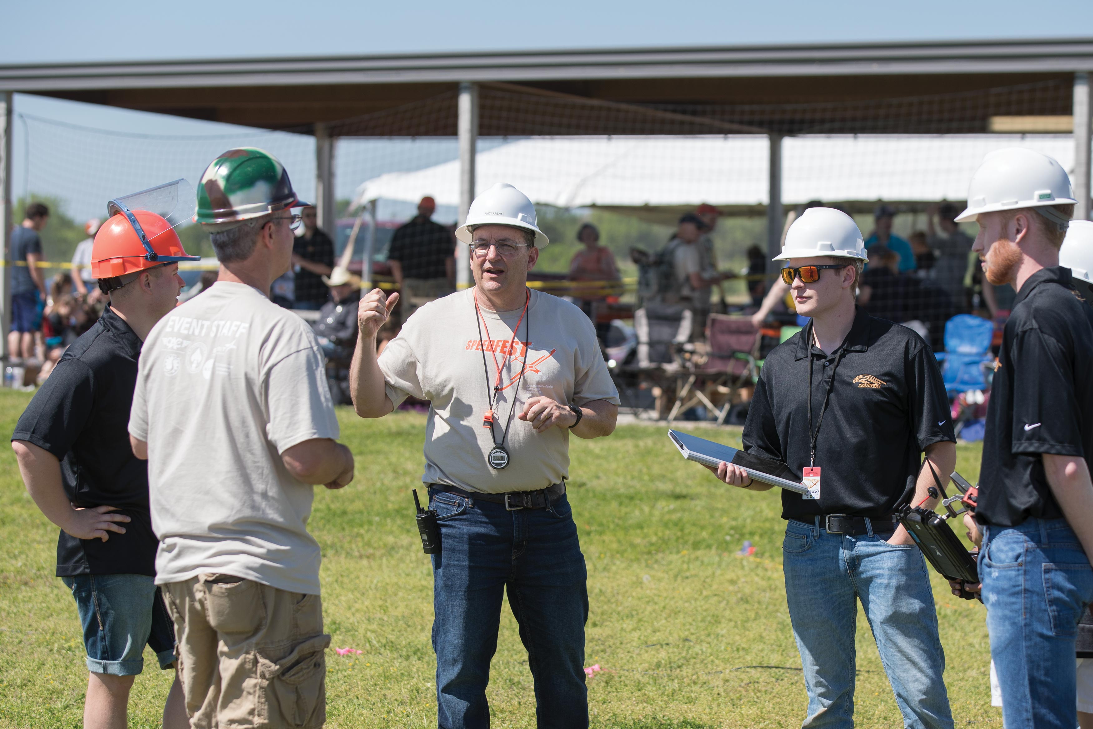 Dr. Andy Arena (center) championed the idea of Speedfest as a way to showcase the abilities of students, both college and high school, using an aircraft design, build and fly competition. The annual event continues to grow and draws hundreds of students each year.