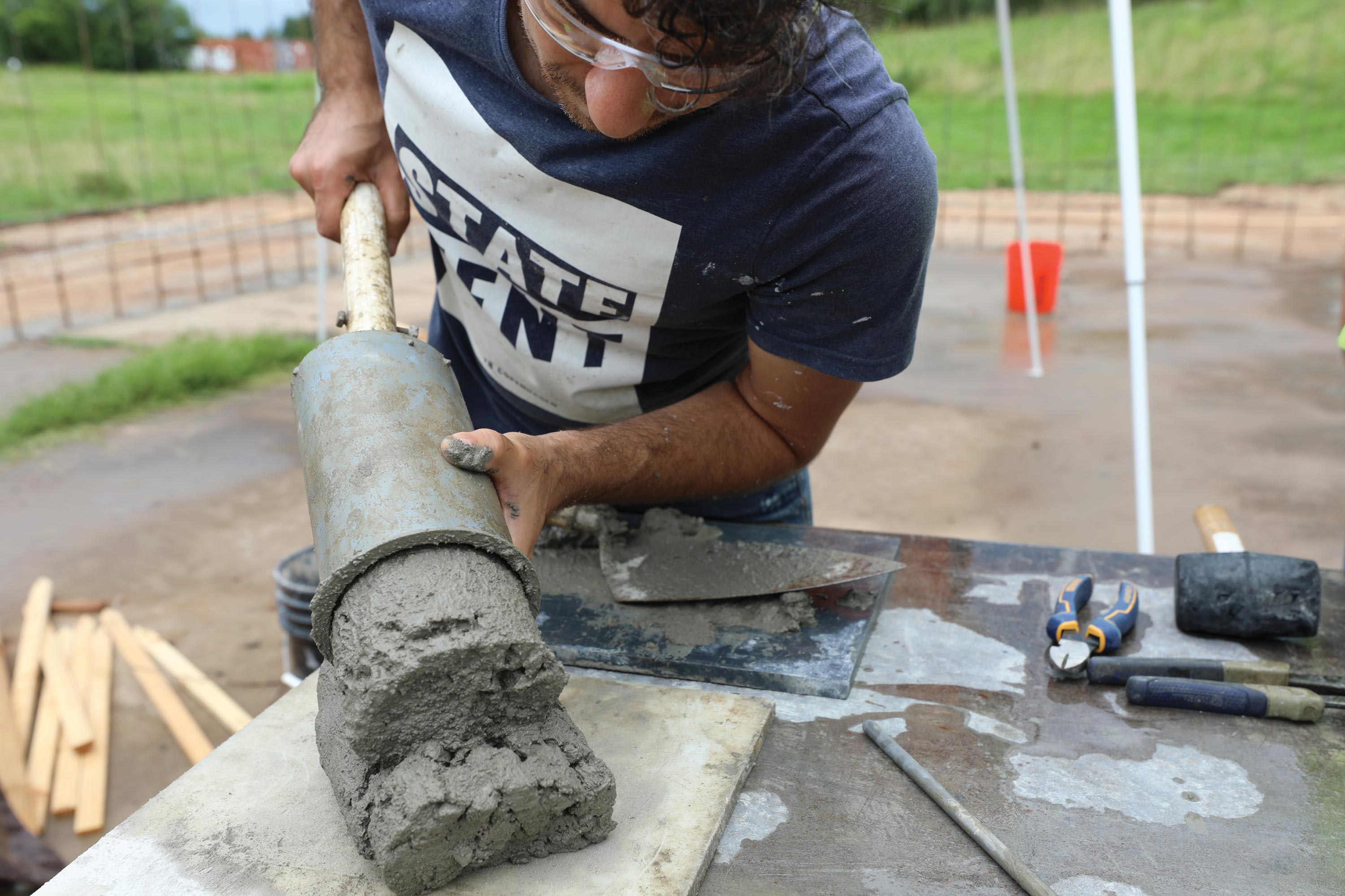 Masoud Forsat tests the concrete being used for the 3D printed structure.