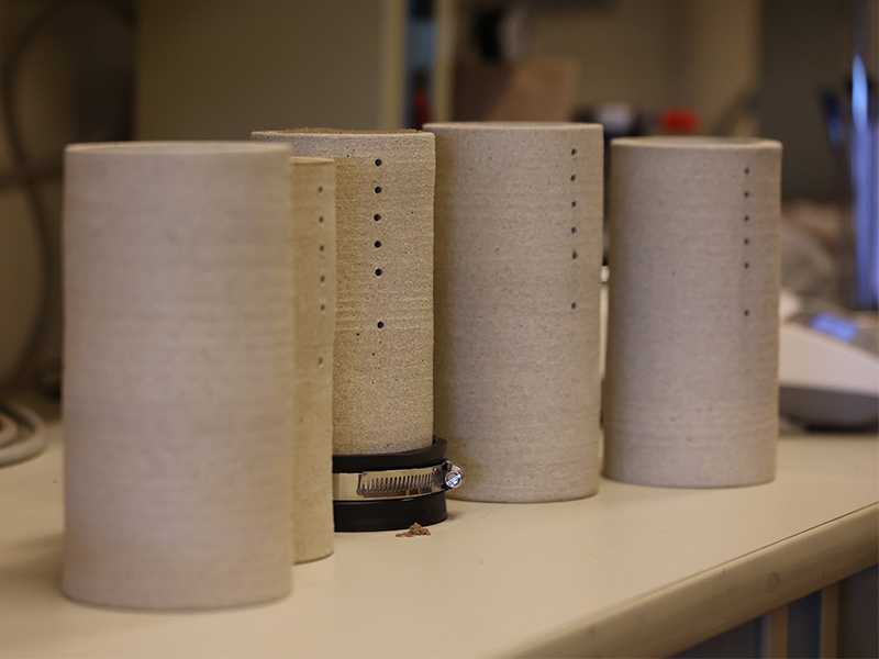 The Prairie Arts Center collaborated with Storm Water Lab to create these ceramic cylinders for research.