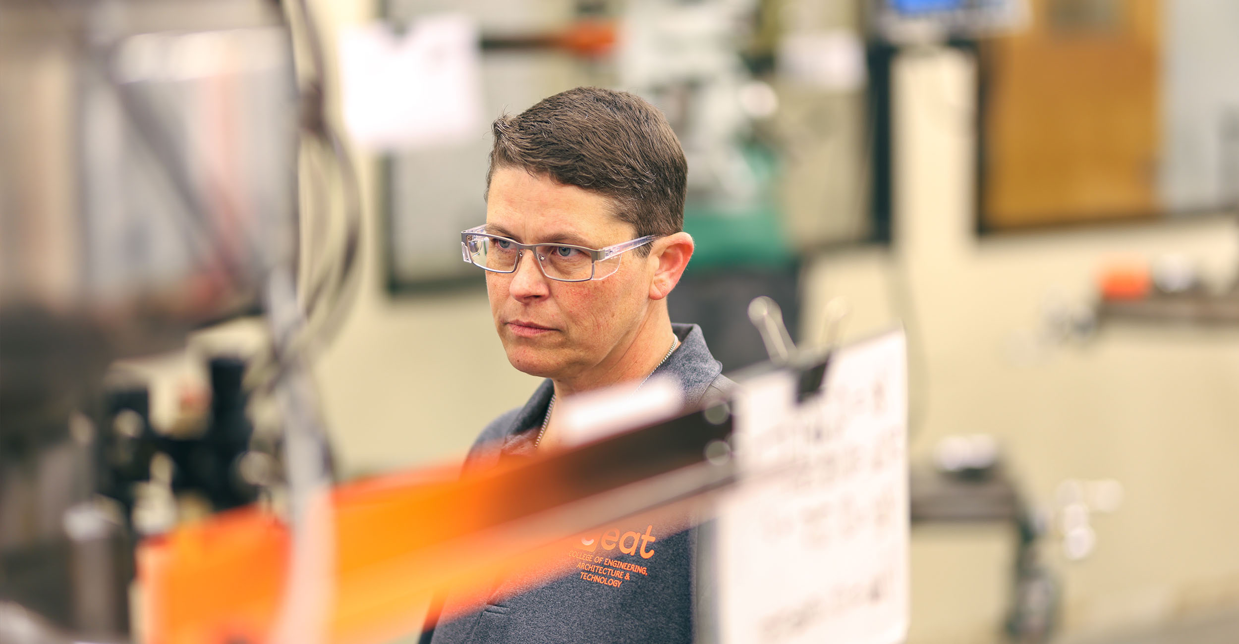 A person stands inside an engineering laboratory.