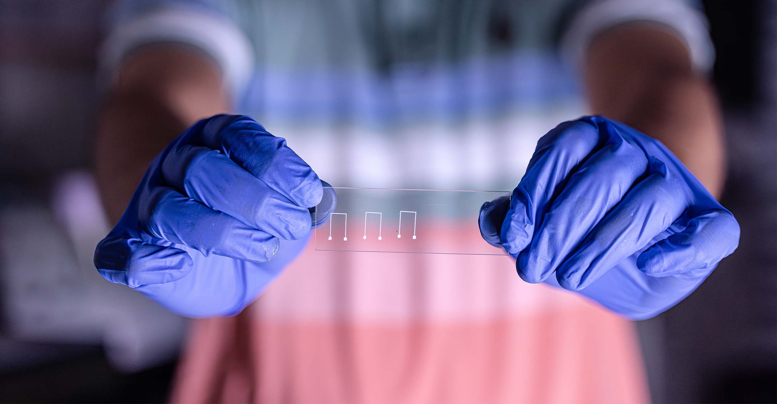 A man holds a circuit designed in the Additive Materials and Manufacturing Lab at Oklahoma State University.