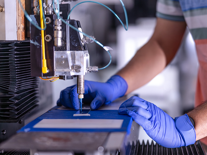 A man uses equipment in the Advanced Materials and Additive Manufacturing Lab at Oklahoma State University.