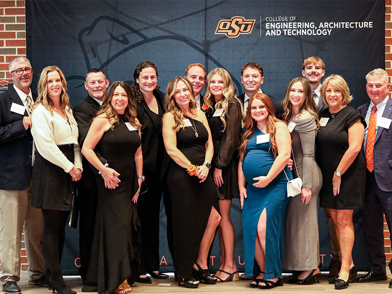 A group family picture in front of a black CEAT photo backdrop.
