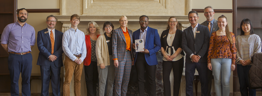 Author Neo Kalungu-Banda poses with Oklahoma State University President Kayse Shrum and faculty and staff to celebrate his donation of two books to the OSU library.